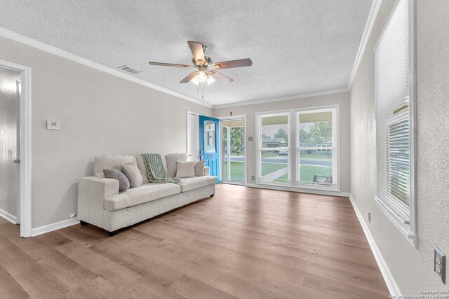 239 Banbridge, San Antonio, TX 78223 - living area featuring wood finished floors, a textured ceiling, ornamental molding, a ceiling fan, and baseboards