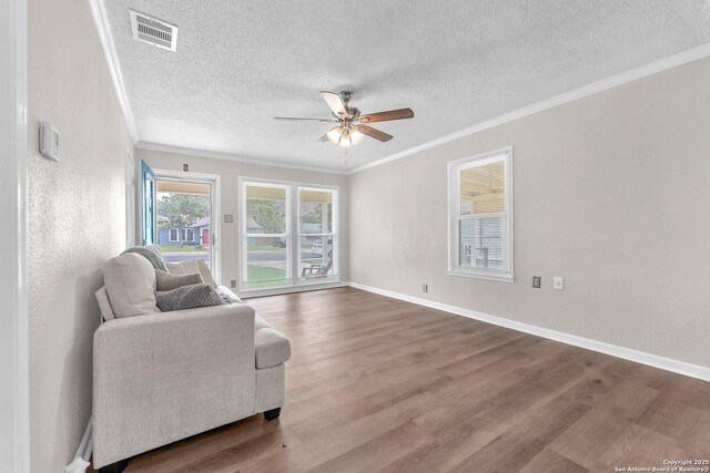 239 Banbridge, San Antonio, TX 78223 - sitting room featuring ornamental molding, wood finished floors, ceiling fan, a textured ceiling, and baseboards