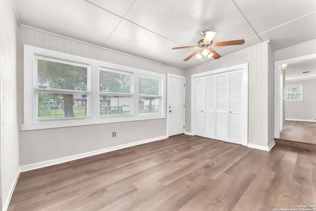 239 Banbridge, San Antonio, TX 78223 - unfurnished bedroom featuring crown molding, wood finished floors, a closet, baseboards, and wood walls