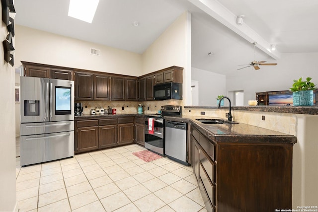 585 Oak Bend Dr, Bandera, TX 78003 - kitchen featuring stainless steel appliances, a peninsula, a sink, backsplash, and dark brown cabinets
