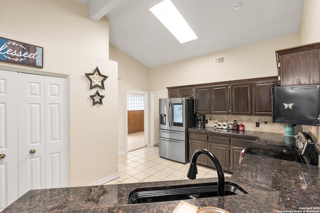 585 Oak Bend Dr, Bandera, TX 78003 - kitchen with stainless steel fridge, black range with electric stovetop, a sink, dark brown cabinets, and light tile patterned flooring