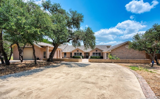 585 Oak Bend Dr, Bandera, TX 78003 - view of front of house with brick siding, dirt driveway, and a garage
