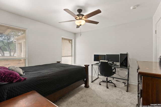 585 Oak Bend Dr, Bandera, TX 78003 - bedroom featuring carpet floors, a ceiling fan, a desk, and baseboards