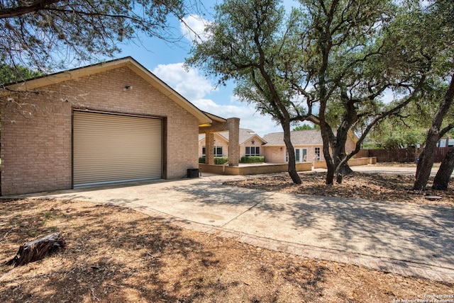 585 Oak Bend Dr, Bandera, TX 78003 - single story home featuring concrete driveway, brick siding, and a garage