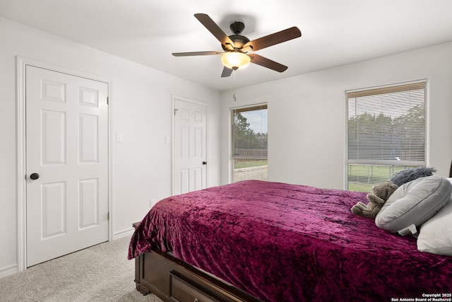585 Oak Bend Dr, Bandera, TX 78003 - bedroom with light carpet, baseboards, and ceiling fan