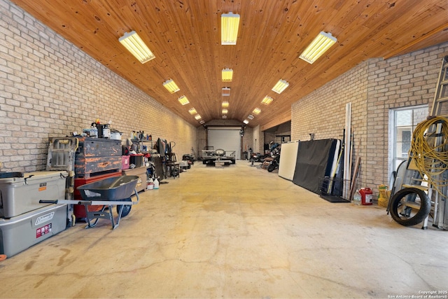 585 Oak Bend Dr, Bandera, TX 78003 - misc room with brick wall, lofted ceiling, and concrete flooring