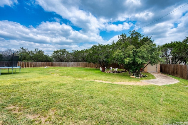 585 Oak Bend Dr, Bandera, TX 78003 - view of yard featuring a trampoline and an outbuilding