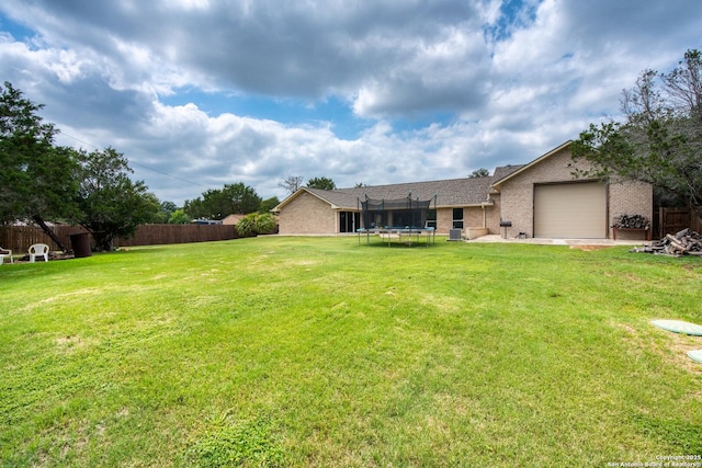 585 Oak Bend Dr, Bandera, TX 78003 - view of yard with a trampoline and an attached garage