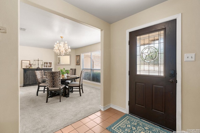 585 Oak Bend Dr, Bandera, TX 78003 - entrance foyer featuring carpet flooring, a chandelier, tile patterned flooring, and baseboards