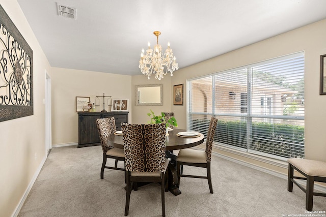 585 Oak Bend Dr, Bandera, TX 78003 - dining area with light carpet, a chandelier, and baseboards