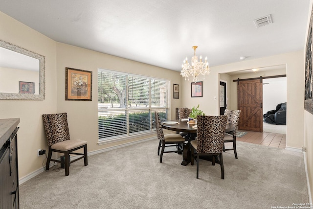 585 Oak Bend Dr, Bandera, TX 78003 - dining space with a barn door, a chandelier, light carpet, and baseboards