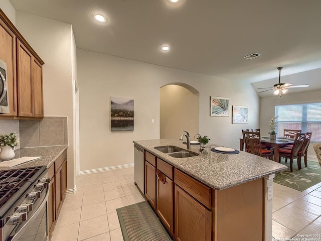 2824 Lake Highlands, Schertz, TX 78108 - kitchen featuring a sink, appliances with stainless steel finishes, arched walkways, light tile patterned flooring, and ceiling fan