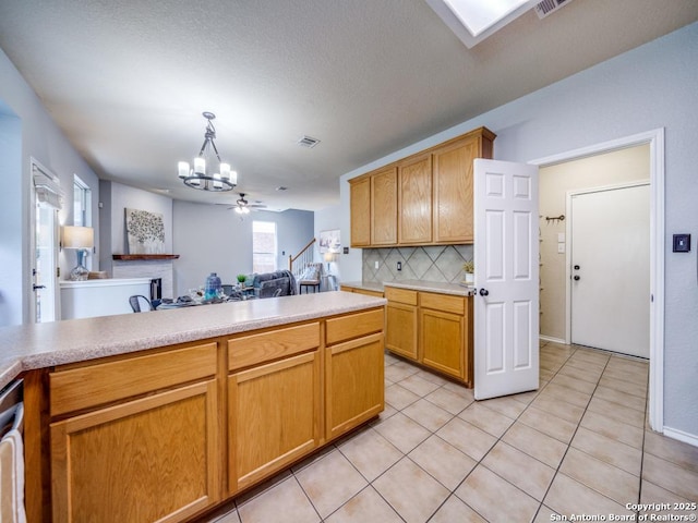 520 Foxford Run Dr, Schertz, TX 78108 - kitchen with a chandelier, decorative backsplash, light countertops, light tile patterned floors, and hanging light fixtures