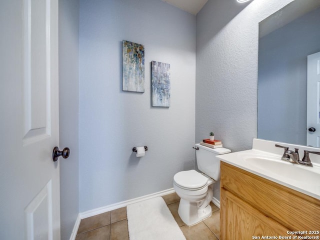 520 Foxford Run Dr, Schertz, TX 78108 - half bathroom featuring toilet, vanity, tile patterned flooring, and baseboards