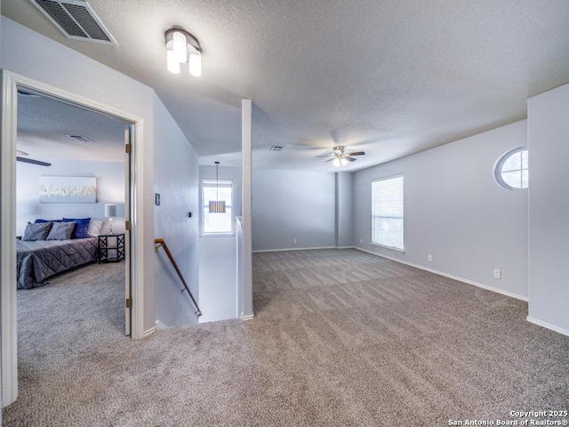 520 Foxford Run Dr, Schertz, TX 78108 - carpeted empty room featuring a ceiling fan, a textured ceiling, healthy amount of natural light, and baseboards