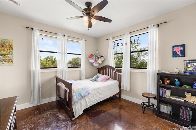 122 Twisting Oaks Ct, Pipe Creek, TX 78063 - bedroom with finished concrete floors, baseboards, and ceiling fan