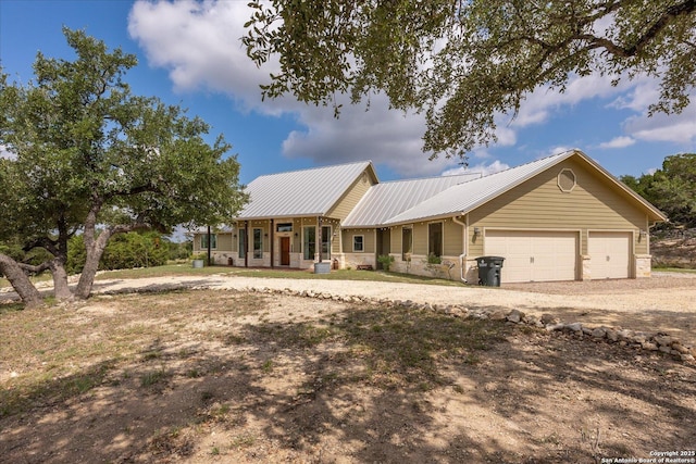 122 Twisting Oaks Ct, Pipe Creek, TX 78063 - view of front of home with dirt driveway, an attached garage, and metal roof