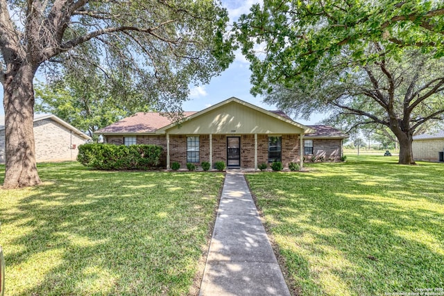105 S Bluebonnet, Uvalde, TX 78801 - view of front facade featuring a front lawn and brick siding
