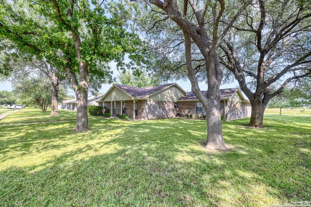 105 S Bluebonnet, Uvalde, TX 78801 - ranch-style home featuring a front yard and brick siding