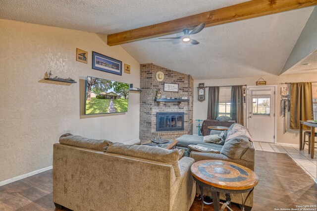 105 S Bluebonnet, Uvalde, TX 78801 - living room with ceiling fan, a textured wall, wood finished floors, a textured ceiling, and baseboards