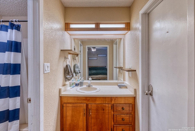 105 S Bluebonnet, Uvalde, TX 78801 - full bathroom with a textured wall, vanity, a shower with curtain, and a textured ceiling