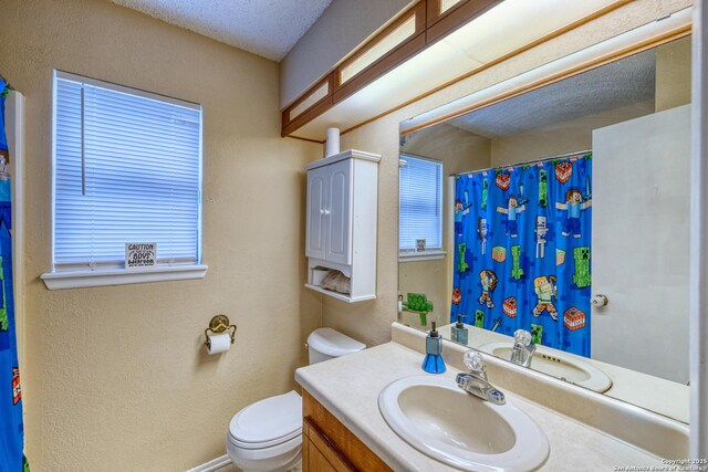 105 S Bluebonnet, Uvalde, TX 78801 - full bath with toilet, vanity, a textured wall, and a shower with shower curtain