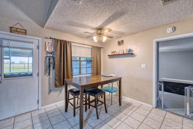 105 S Bluebonnet, Uvalde, TX 78801 - dining space with a textured wall, light tile patterned floors, a textured ceiling, plenty of natural light, and a ceiling fan