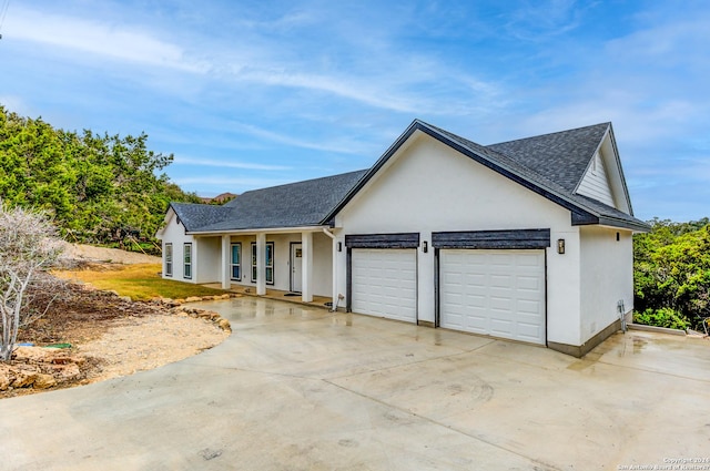 524 Flaman, Canyon Lake, TX 78133 - view of front of house with driveway, an attached garage, stucco siding, a shingled roof, and a porch