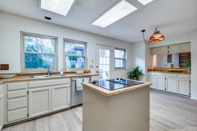 16930 Hidden Timber Wood, San Antonio, TX 78248 - kitchen featuring stainless steel dishwasher, a sink, light wood-style floors, black electric stovetop, and a center island