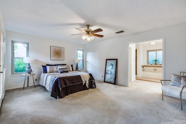 16930 Hidden Timber Wood, San Antonio, TX 78248 - carpeted bedroom featuring a textured ceiling, ensuite bath, and ceiling fan