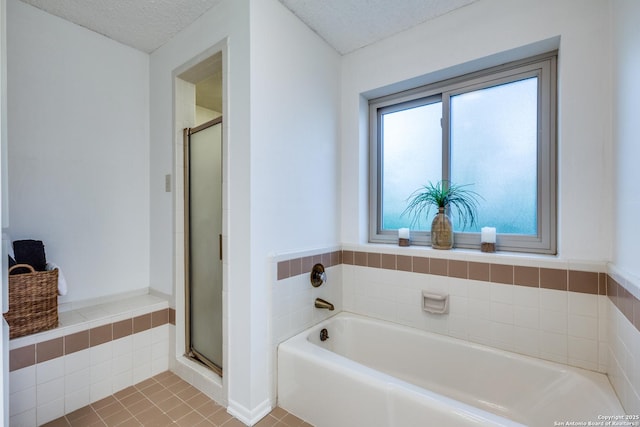 16930 Hidden Timber Wood, San Antonio, TX 78248 - bathroom with a garden tub, a textured ceiling, a shower stall, and tile patterned flooring