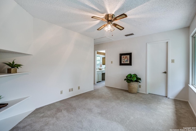 16930 Hidden Timber Wood, San Antonio, TX 78248 - unfurnished room featuring a ceiling fan, carpet flooring, a textured ceiling, attic access, and baseboards
