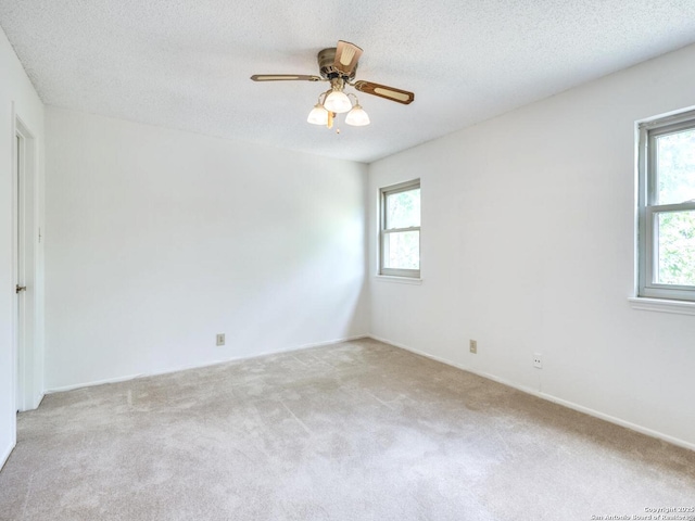 16930 Hidden Timber Wood, San Antonio, TX 78248 - spare room featuring light carpet, a ceiling fan, and a textured ceiling