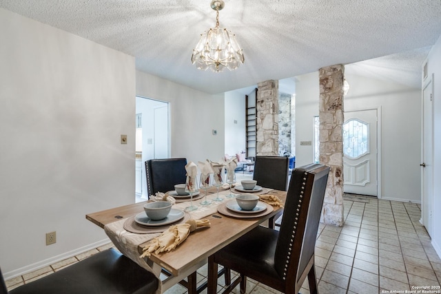 16930 Hidden Timber Wood, San Antonio, TX 78248 - dining space featuring a chandelier, a textured ceiling, ornate columns, light tile patterned flooring, and baseboards