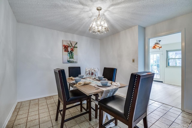 16930 Hidden Timber Wood, San Antonio, TX 78248 - dining space featuring a chandelier, a textured ceiling, light tile patterned floors, and baseboards