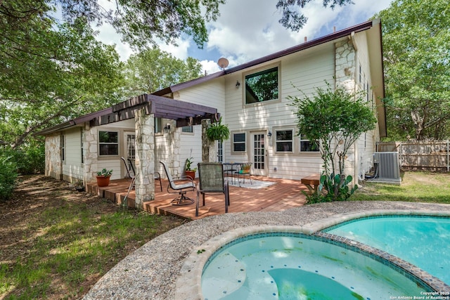 16930 Hidden Timber Wood, San Antonio, TX 78248 - back of property with a deck, central AC, a pool with connected hot tub, outdoor dining space, and a pergola