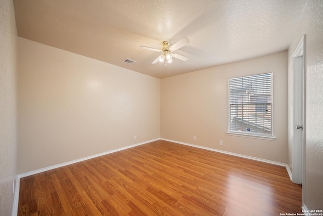 7731 Cedar Farm, San Antonio, TX 78239 - spare room with ceiling fan, light wood-style flooring, baseboards, and a textured ceiling