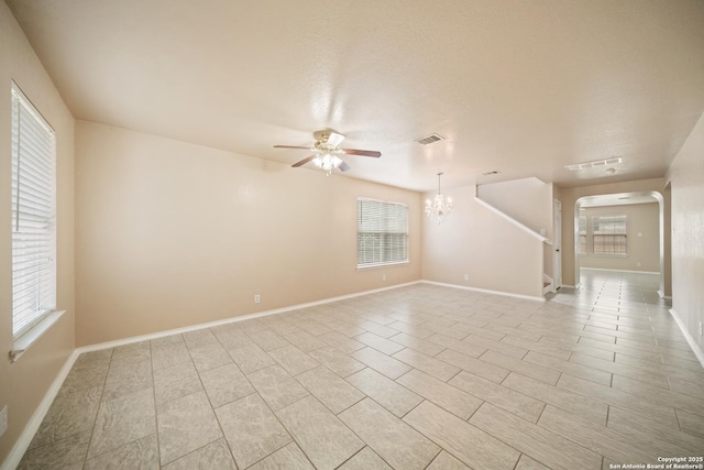 7731 Cedar Farm, San Antonio, TX 78239 - spare room with arched walkways, a ceiling fan, a chandelier, and baseboards