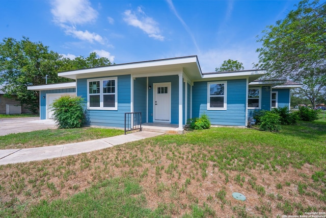 234 Gaiety Ln, Kirby, TX 78219 - view of front facade with an attached garage, a front yard, and concrete driveway