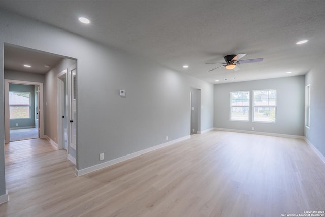 234 Gaiety Ln, Kirby, TX 78219 - unfurnished room with ceiling fan, light wood-style floors, healthy amount of natural light, recessed lighting, and baseboards