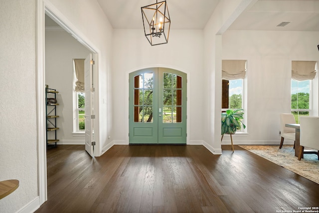 117 Sabella, Spring Branch, TX 78070 - entrance foyer with french doors, healthy amount of natural light, a chandelier, and dark wood-style floors