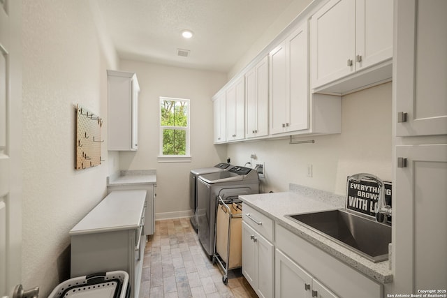 117 Sabella, Spring Branch, TX 78070 - laundry room featuring washer and dryer, cabinet space, light wood-style floors, baseboards, and recessed lighting