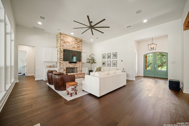 117 Sabella, Spring Branch, TX 78070 - living area with dark wood-style flooring, a ceiling fan, a brick fireplace, recessed lighting, and baseboards