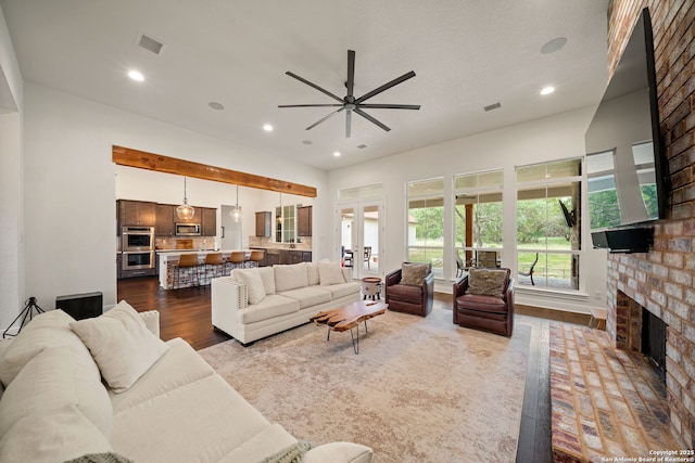 117 Sabella, Spring Branch, TX 78070 - living room featuring dark wood-style floors, a ceiling fan, a fireplace, and recessed lighting