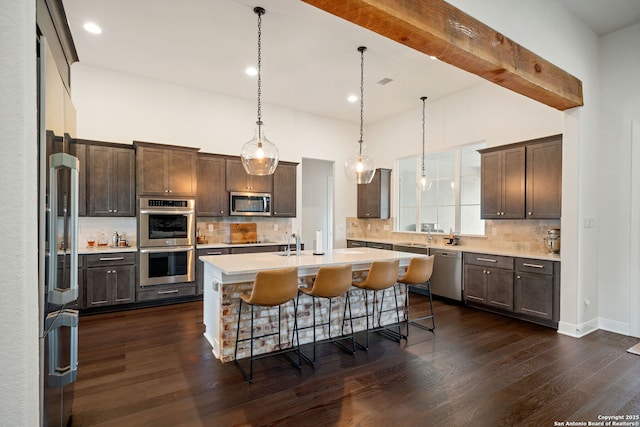 117 Sabella, Spring Branch, TX 78070 - kitchen with stainless steel appliances, a center island with sink, light countertops, dark brown cabinets, and recessed lighting