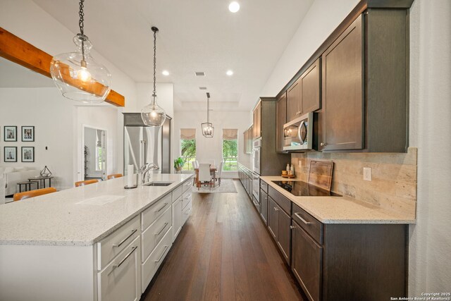 117 Sabella, Spring Branch, TX 78070 - kitchen featuring appliances with stainless steel finishes, a spacious island, recessed lighting, dark wood-style flooring, and decorative backsplash