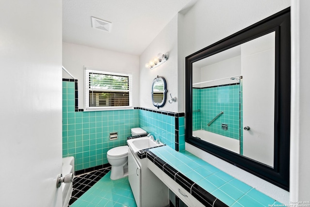 435 Sharon, San Antonio, TX 78216 - full bath featuring toilet, tile patterned floors, vanity, tile walls, and  shower combination