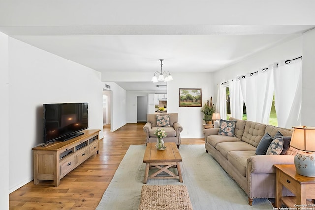 435 Sharon, San Antonio, TX 78216 - living room with light wood-style floors, a chandelier, and baseboards
