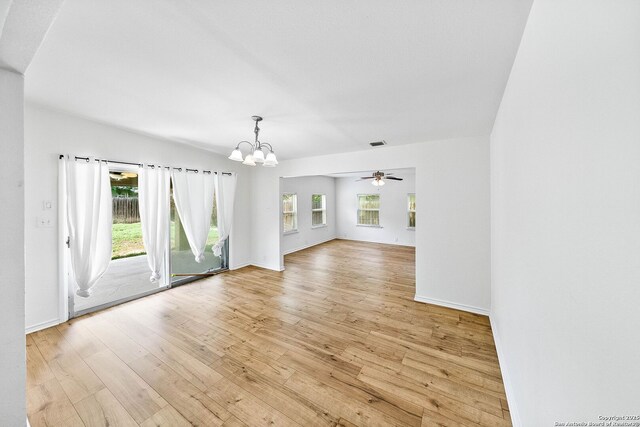 435 Sharon, San Antonio, TX 78216 - unfurnished living room with a chandelier, plenty of natural light, light wood-type flooring, and baseboards