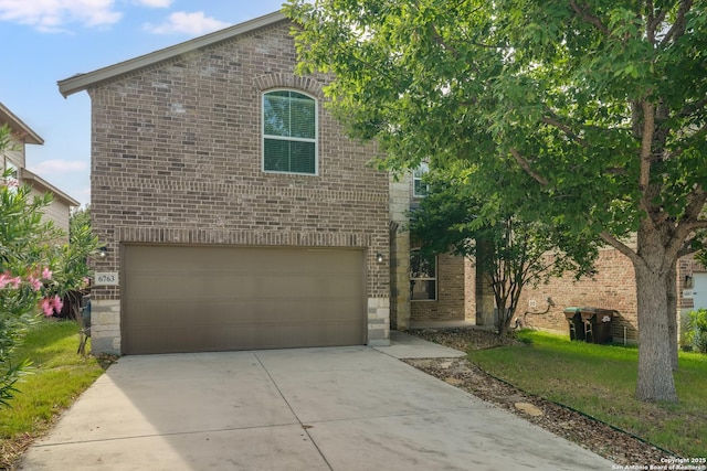 6763 Indian Ldg, San Antonio, TX 78253 - view of front of property featuring brick siding, an attached garage, concrete driveway, and a front yard